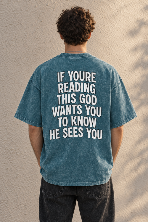 Model wearing the UNQLFD teal mineral wash tee with God Sees You back print