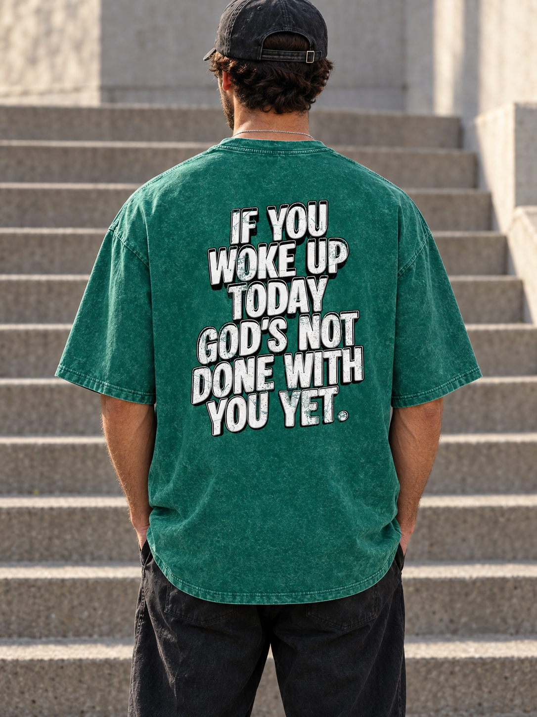 Model wearing GODS NOT DONE WITH YOU Snow Wash Tee from behind, showing the white distressed back graphic.