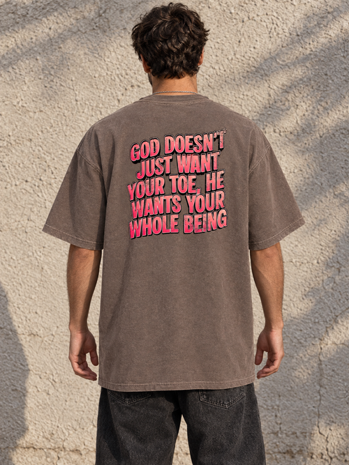 Model wearing GOD DOESN'T WANT YOUR TOE Vintage Wash Tee from behind, showing the pink statement graphic and normal tee length.